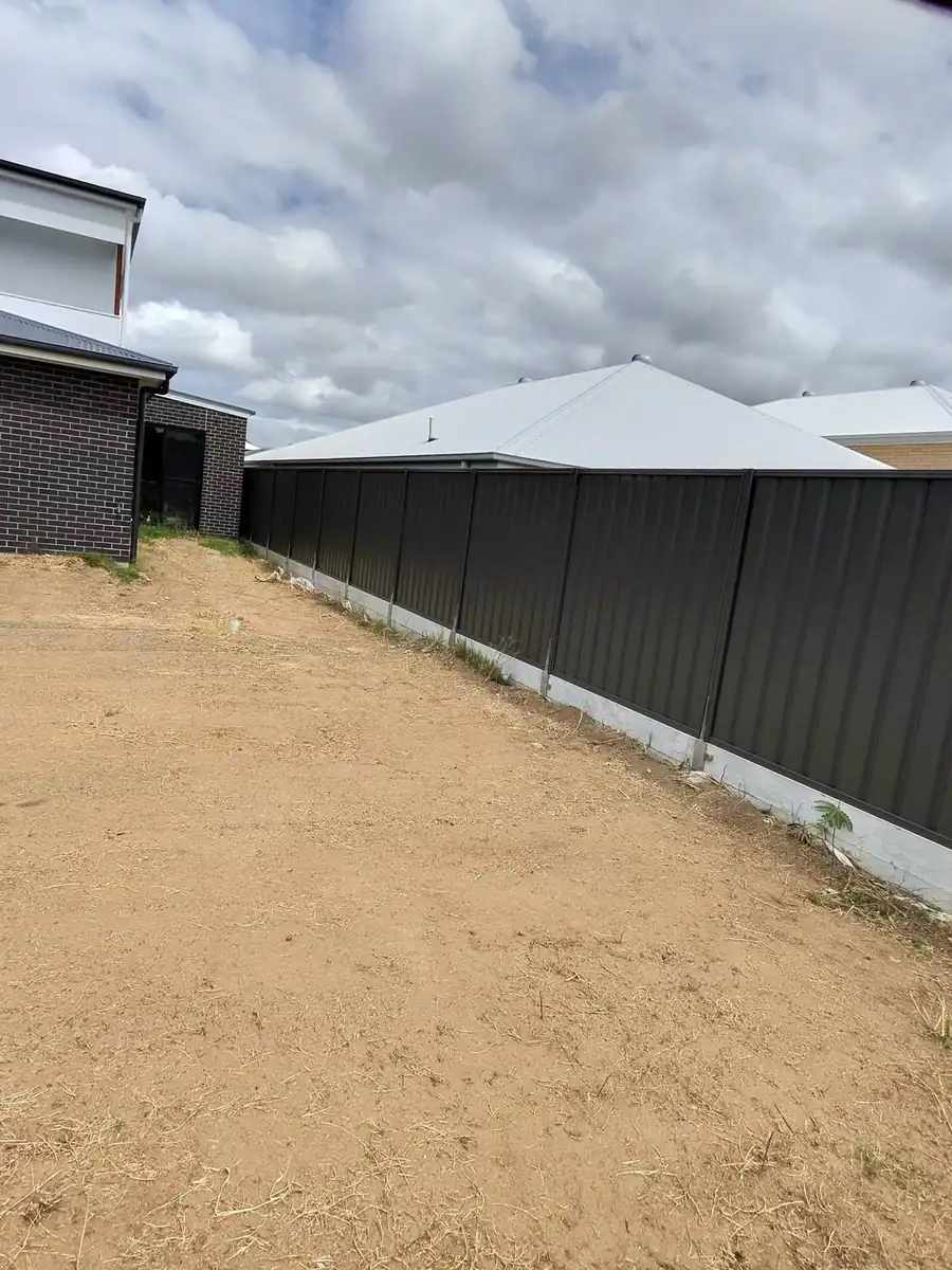 Colorbond fence panels installed on a concrete plinth