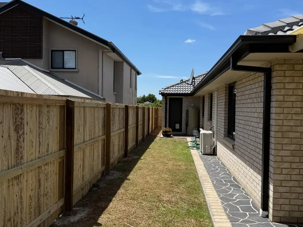 Treated pine paling fence along a narrow side yard