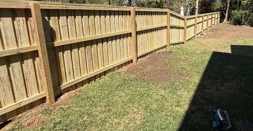Timber paling fence built by JC Fencing along a backyard boundary
